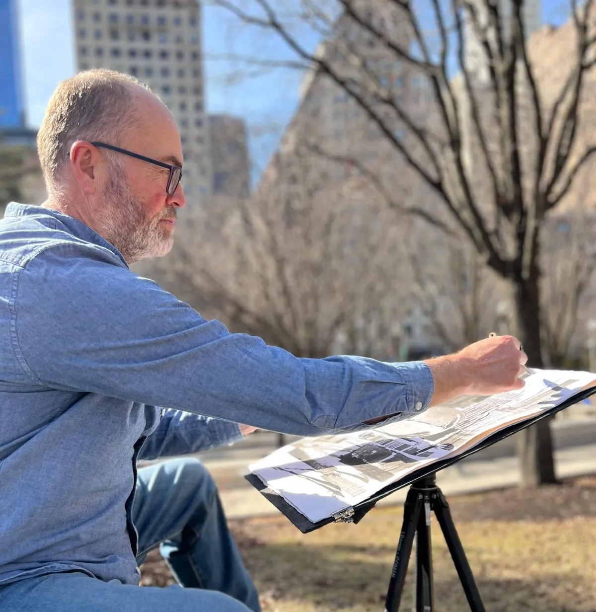 Paul Kenton sketching en plein air in a city park
