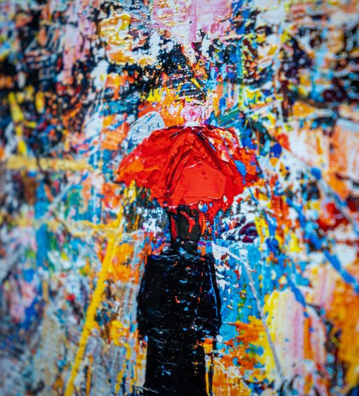 A Paul Kenton painting of a lone figure carrying a bright red umbrella through a vivid, rain-soaked city street